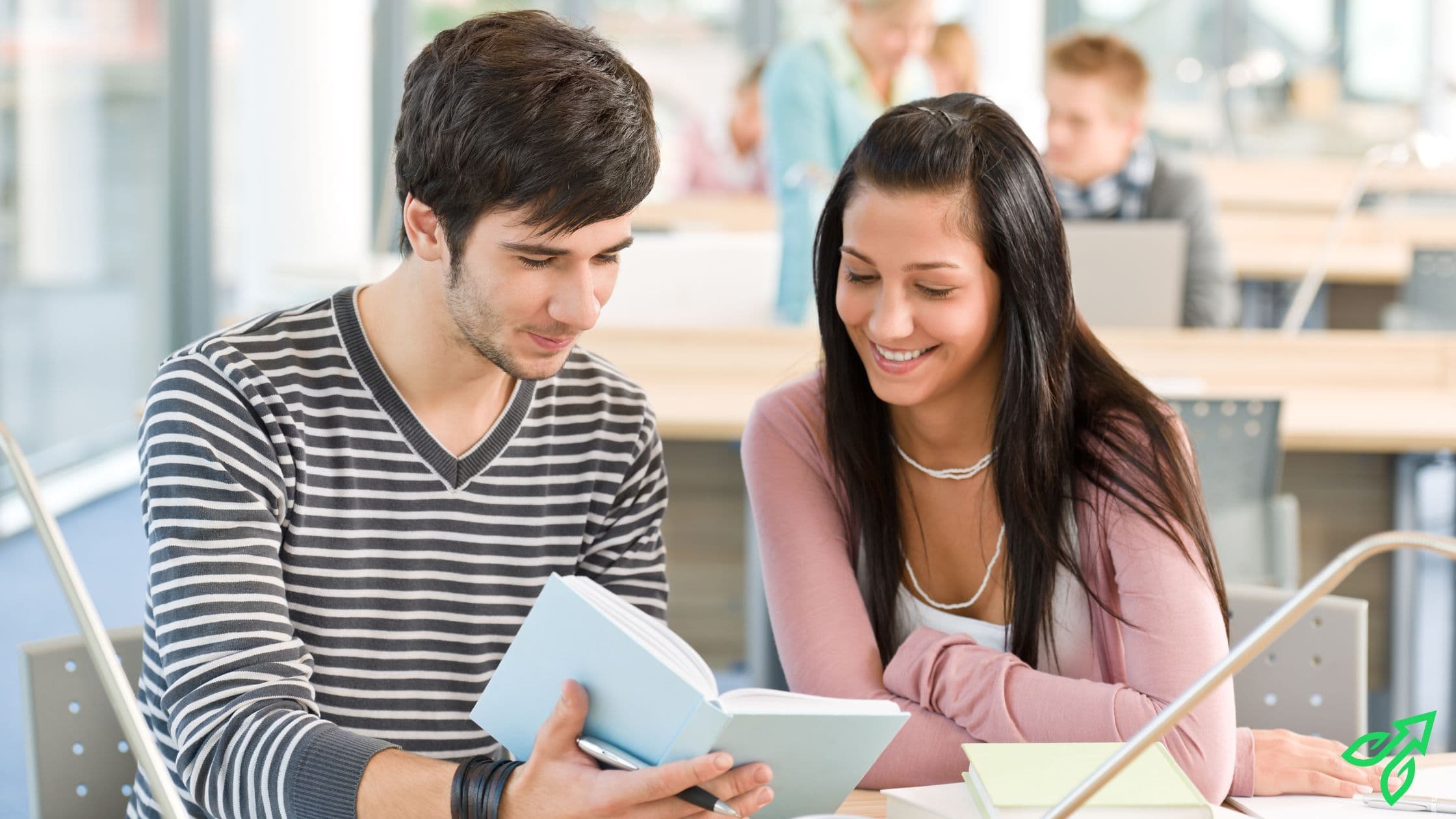 Two students reading a single book together